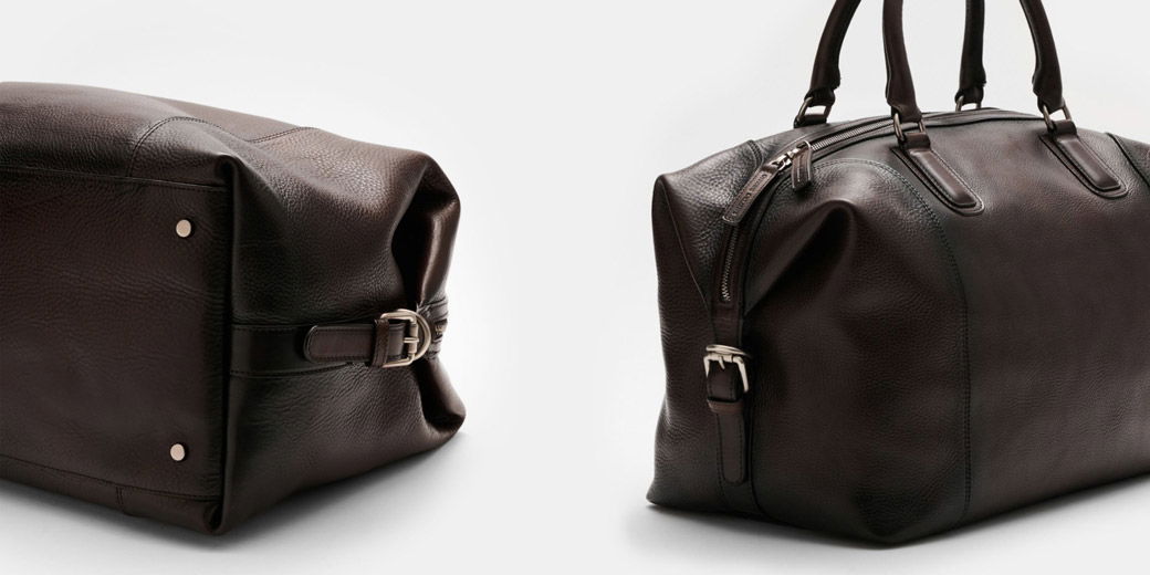Dark brown leather duffel bag with silver hardware, buckles on the sides, and sturdy handles, shown from two angles.