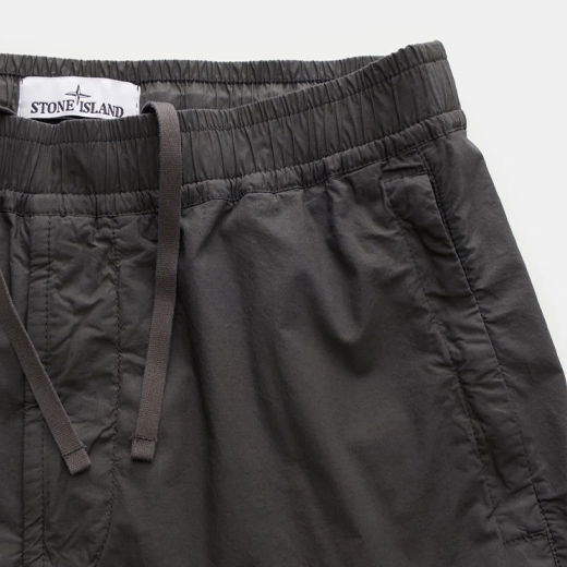 Herren-Joggpants in Anthrazit mit elastischem Bund, Tunnelzug und sichtbarem Stone Island Markenlabel innen am Bund.