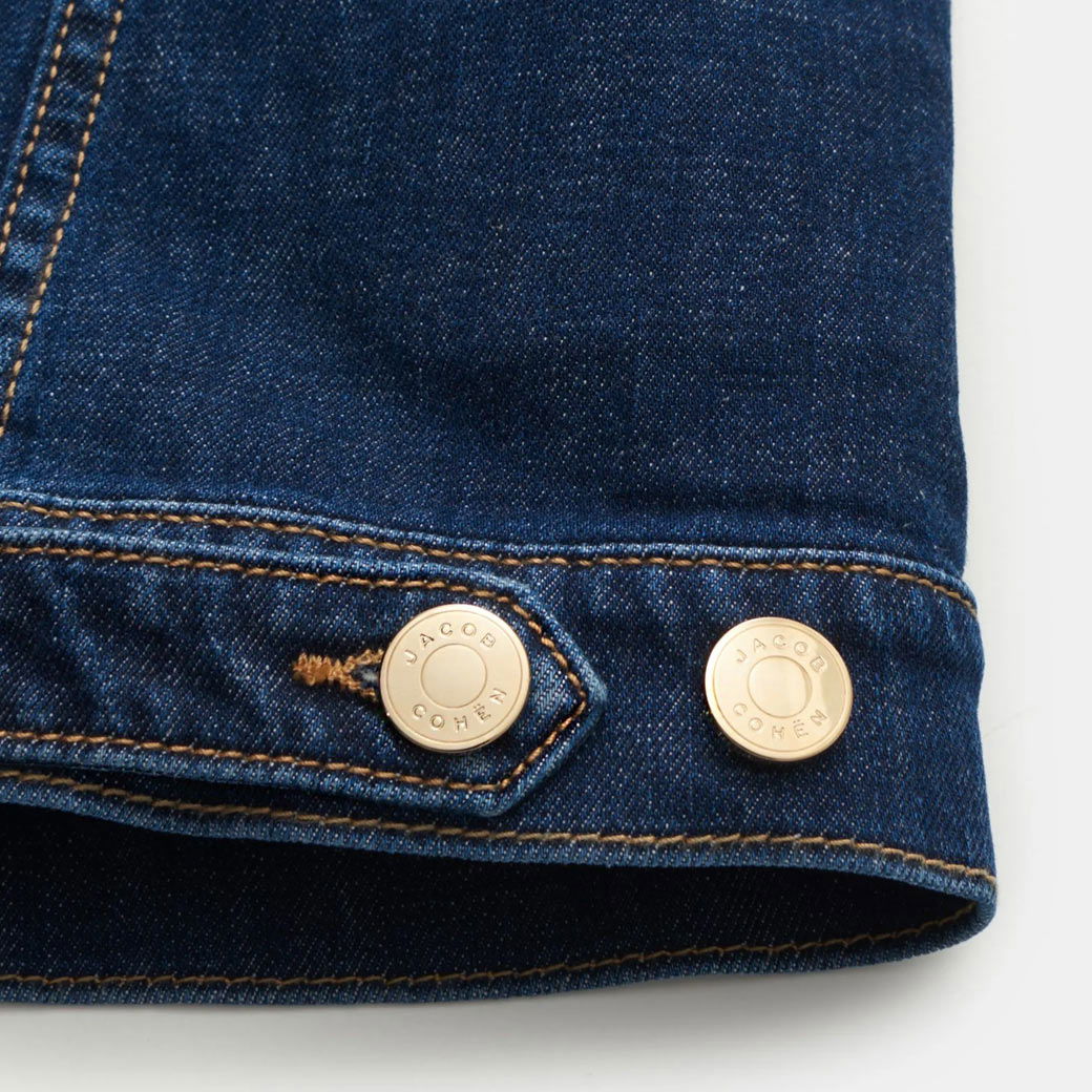Dunkelblaue Herren-Jeansjacke mit goldfarbenen Metallknöpfen, Detailansicht der Knopfleiste und Nahtverarbeitung.