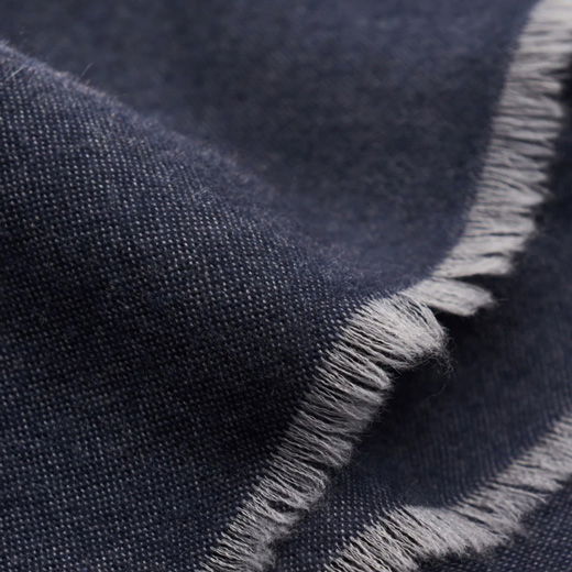 Blauer Herrenschal aus feinem Stoff mit weißen, ausgefransten Enden, Detailaufnahme der Textur und Fransen.