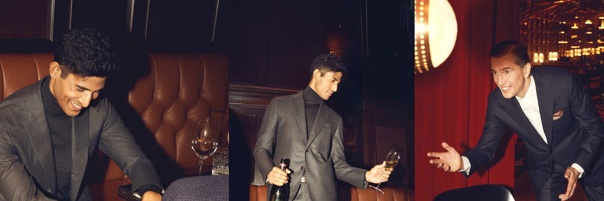 Drei Herren in grauem und blauem Anzug lachen und stoßen in eleganter, festlicher Bar mit Wein- und Champagnergläsern an. Drei Herren in grauem und blauem Anzug lachen und stoßen in eleganter, festlicher Bar mit Wein- und Champagnergläsern an.