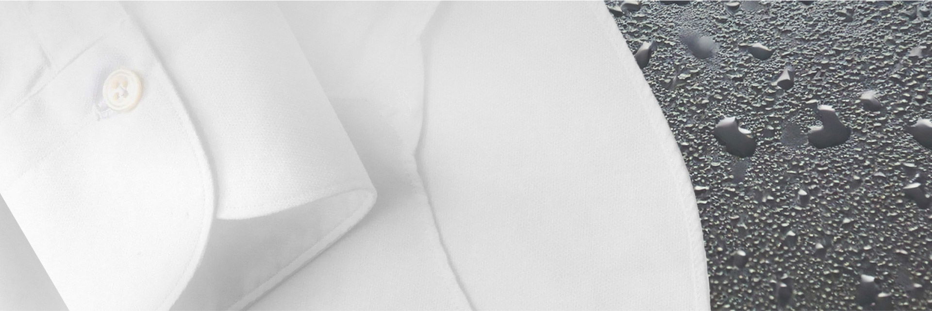 Nahaufnahme eines weißen Herrenhemdsärmel mit Knopf, auf schwarzem Untergrund mit Wasserperlen liegend. Nahaufnahme eines weißen Herrenhemdsärmel mit Knopf, auf schwarzem Untergrund mit Wasserperlen liegend.