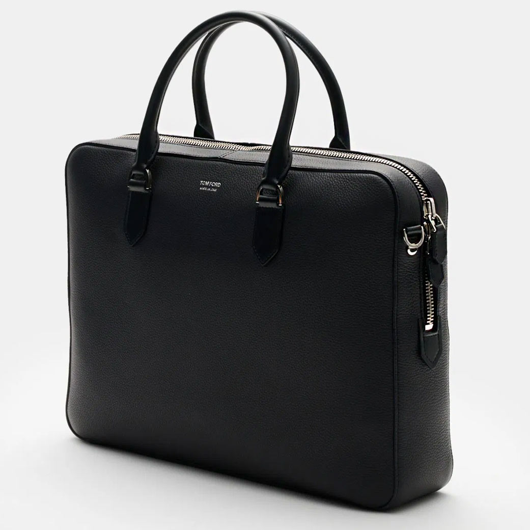 Schwarze Leder-Business-Tasche mit zwei Griffen, silbernem Reißverschluss und kleiner Designeraufschrift 'TOM FORD' vorne.