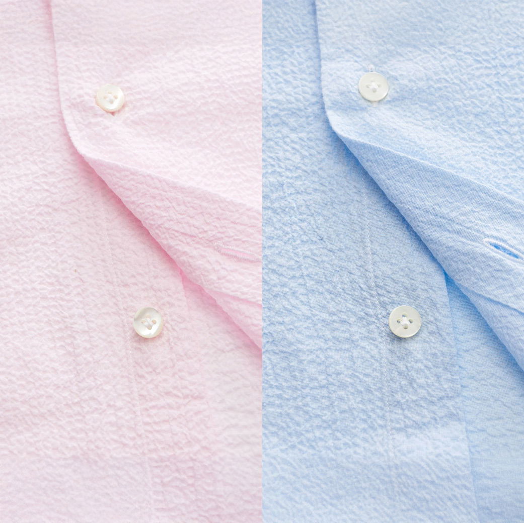 Zweigeteiltes Bild mit Knopfleisten zweier Herren-Seersuckerhemden in zartem Rosa und hellblau, Details der Struktur sichtbar.
