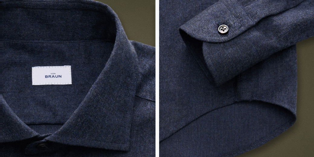 Dunkelblaues Hemd aus feinem Fischgrätstoff, Detailansicht von Kragen mit Label und Manschette mit Knopf.