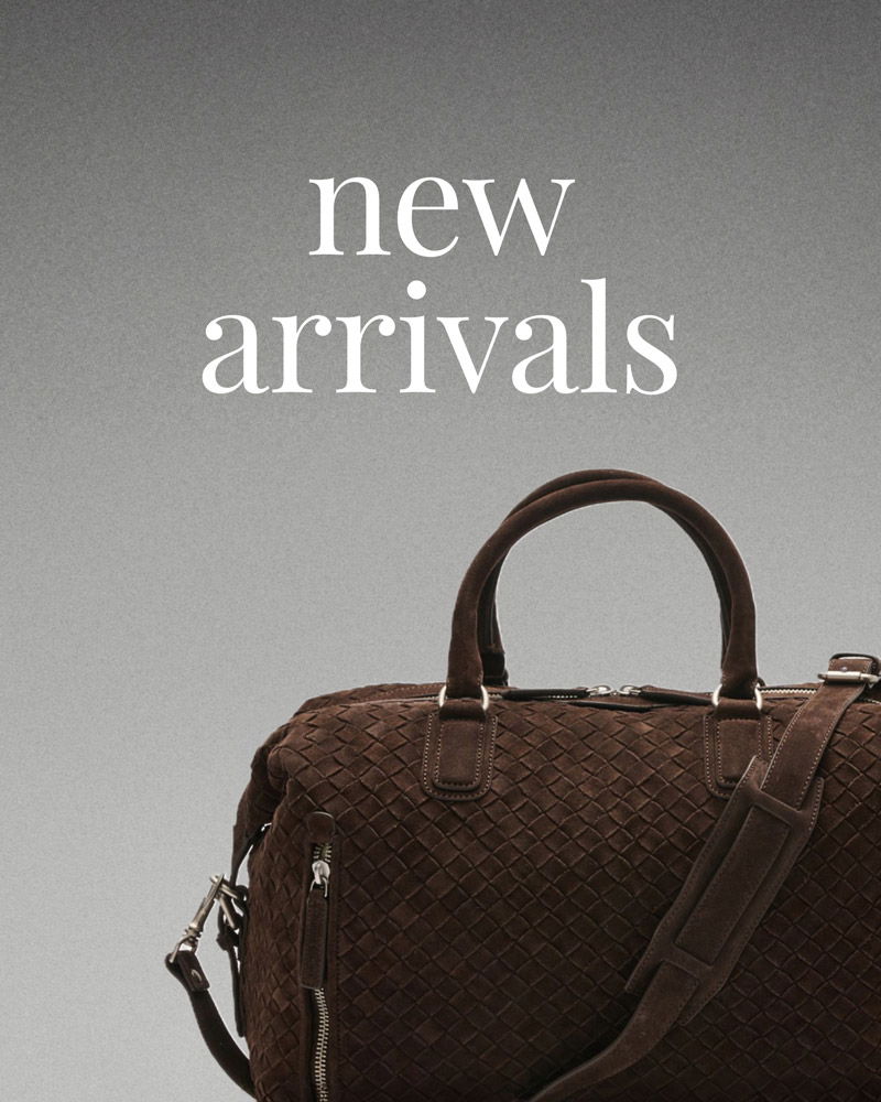 Brown woven leather handbag with handles and shoulder strap under the text 'new arrivals' on a gray gradient background.
