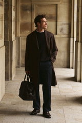 Shop by Look 01 Denis Cebulec in Lardini for BRAUN Hamburg, front view of model wearing dark brown wool coat by Lardini over dark brown cashmere jumper from Aida Barni, white piqué T-shirt 'TP' from 04651/ A trip in a bag, navy trousers from Lardini, dark