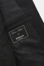 Close-up inside view of Cesare Attolini Cashmere Coat dark grey patterned showing smooth black lining, classic welt pocket, and branded label.