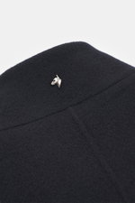 Close-up front view of Montecore Cashmere Coat navy collar with silver horse head pin, made of pure cashmere, soft touch, slim fit, four-button style, stand-up collar with removable beaver fur trim, slanted welt pockets, unlined, one inside pocket, elegan