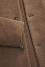 Close-up front view of the Montecore Cashmere Coat taupe showing soft pure cashmere fabric, four-button style, and slanted welt pockets.