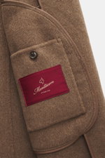 Montecore Cashmere Coat taupe shown from a close-up side angle, highlighting soft pure cashmere fabric, button, and red Montecore label.