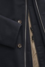 Close-up front view of Montecore Down short coat dark navy showing zipper, buttons with logo, and wool fabric texture.

<p>This exclusive short coat from MONTECORE made of fine virgin wool with a removable double front and warming down filling stylishly a