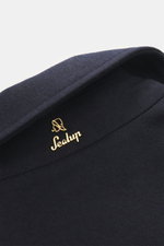 Close-up top view of Sealup Down short coat 'Ambroeus' dark navy collar made of pure wool with discreet metal logo, showcasing soft touch and premium craftsmanship.