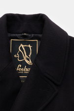 Close-up front view of Sealup Pea coat 'Maestrale' navy wool-cashmere blend with wide lapel collar and embroidered label.

Description: <p>Inspired by rough seas and traditional nautical clothing, SEALUP has come up with an elegant reinterpretation of the