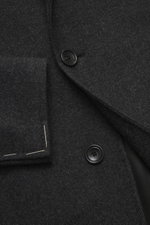 Close-up of Tagliatore Wollmantel graubraun/taupe gemustert showing soft pure new wool fabric with classic herringbone pattern, three-button slim fit, and lapel from front angle.

<p>Klassische Eleganz von TAGLIATORE: Gefertigt aus reiner Schurwolle im 