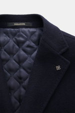 Close-up front view of Tagliatore Coat navy showing notched lapel with logo pin, quilted half lining, and soft virgin wool texture. 

Description: <p>Elegant through the winter: The wool coat by TAGLIATORE combines a classic silhouette with luxurious wear