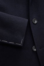 Close-up front view of Tagliatore Coat navy showing pure virgin wool fabric, three-button style, notched lapel with logo pin, and soft touch.

Description: <p>Elegant through the winter: The wool coat by TAGLIATORE combines a classic silhouette with luxur