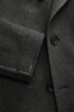 Close-up front view of Tagliatore Wool Coat Dark Grey Melange showing double-breasted buttons, peaked lapel with pin, and cuff details.

<p>TAGLIATORE's signature understated elegance is expressed through this impeccably tailored double-breasted coat. Cra