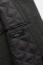 Close-up view of the Tagliatore Wool Coat Dark Grey Melange showing its quilted half-lined interior, pure virgin wool exterior, and inside pocket with label.

<p>TAGLIATORE's signature understated elegance is expressed through this impeccably tailored dou