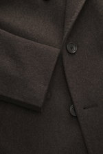 Close-up front view of Tagliatore Wool Coat Dark Grey Melange showing the double-breasted buttons, soft virgin wool fabric, and peaked lapel with pin.

<p>TAGLIATORE's signature understated elegance is expressed through this impeccably tailored double-bre