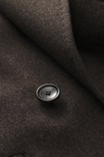Close-up front detail of Tagliatore Wool Coat Dark Grey Melange showing a black button and soft virgin wool fabric texture from a top-down perspective.

<p>TAGLIATORE's signature understated elegance is expressed through this impeccably tailored double-br