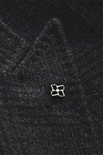 Close-up front detail of Tagliatore Wool coat dark grey/anthracite checked, showing pure new wool fabric with classic Glen check pattern, peaked lapel with pin, and soft texture, photographed from above. Classic elegance from TAGLIATORE: Made from pure wo