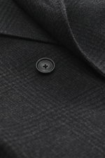 Close-up front detail of Tagliatore Wool coat dark grey/anthracite checked showing soft pure wool fabric, Glen check pattern, button, and peaked lapel from a top-down perspective. 

Description: Classic elegance from TAGLIATORE: Made from pure wool in a t