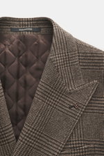 Close-up front view of Tagliatore Wool coat taupe/dark brown checked with peaked lapel, pin, and quilted half-lined interior showing classic Glen check and soft pure new wool fabric. 

Description: <p>Classic elegance from TAGLIATORE: Made from pure wool 