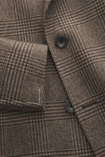 Close-up front view of Tagliatore Wool coat taupe/dark brown checked showing double-breasted three-button style, peaked lapel with pin, classic Glen check pattern, and soft pure new wool fabric.

<p>Classic elegance from TAGLIATORE: Made from pure wool in