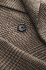 Close-up front view of Tagliatore Wool coat taupe/dark brown checked showing pure new wool fabric with classic Glen check, soft feel, and a black button.