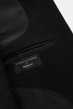 Close-up interior view of the Tagliatore Cashmere Coat Black showing smooth lining fabric, piped breast pocket, and brand label, highlighting winter elegance with Italian sophistication: pure cashmere, soft touch, slim fit, fitted three-button style, notc