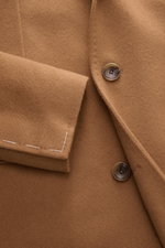 Close-up front view of the Tagliatore Cashmere Coat Light Brown showing soft pure cashmere fabric, tailored three-button style, notched lapel with logo pin, and unfinished sleeve cuffs.

Additional description: 
<p>Winter elegance with Italian sophisticat