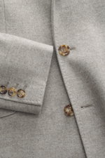 Close-up front view of the Brunello Cucinelli Cashmere Coat grey melange showing buttons and fabric texture, elegant understatement in luxurious pure cashmere with a very soft touch, slim fit, tailored three-button style, adjustable lapel, classic breast 
