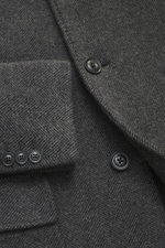 Detailaufnahme aus Nahperspektive des Fay Mantel 'Duty Coat' dunkelgrau meliert mit Fischgratmuster, Knöpfen und Karabinerverschluss.