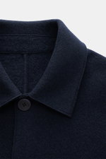 Close-up from above of the collar and top button of the Lunaria Cashmere Cashmere short coat navy in pure cashmere with a soft feel, notched collar, and four-button style.