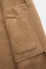 Close-up front view of Lunaria Cashmere Cashmere short coat light brown showing pocket flap and soft pure cashmere texture.