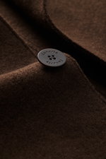 Close-up front view of Lunaria Cashmere Cashmere short coat dark brown showing soft pure cashmere fabric and embossed button.