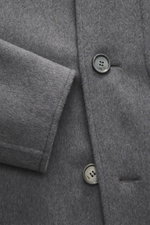 Close-up front angle of Ami Paris Wool coat grey showing soft virgin wool and cashmere mix fabric, five-button placket, short notch lapel, slanted welt pocket, two inside pockets, regular fit, and unconstructed design.