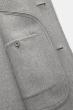 Ami Paris Wool coat grey close-up image from above showing soft-touch virgin wool and cashmere fabric, regular fit, five-button placket, short notch lapel, slanted welt pockets, two inside pockets, and unconstructed design.