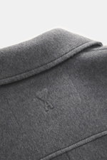 A close-up top-down view of the Ami Paris Wool coat grey showing the soft virgin wool and cashmere blend fabric, short notch lapel, and unconstructed design. Features include a regular fit, five-button placket, slanted welt pockets, and two inside pockets