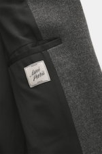 Close-up view of the inside and outer fabric of the Ami Paris Wool coat dark grey melange, showing pure new wool, textured quality, smooth lining fabric, and an inside pocket with label.