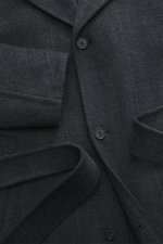 Maison Kitsuné Coat dark grey melange close-up from above showing soft wool and microfiber doubleface fabric, three-button placket, notched collar, slanted welt pockets, tie belt, oversized fit, unconstructed design, back cape with ventilation slits, and 