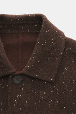 Close-up front top view of the Percival Coat 'Minnesota' brown/white melange showing turn-down collar, five-button placket, and wool blend with twill and slubs. Mix of wool, microfiber, and cotton; twill with inserted slubs; regular fit; five-button plack