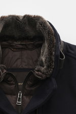 Close-up front angled view of Windsor Short coat 'Rivano' navy showing soft mix of wool, cashmere, microfiber, slim fit, four-button placket, removable double front with faux fur trim and hood, stand-up collar with button tab, zipper chest pocket, side po