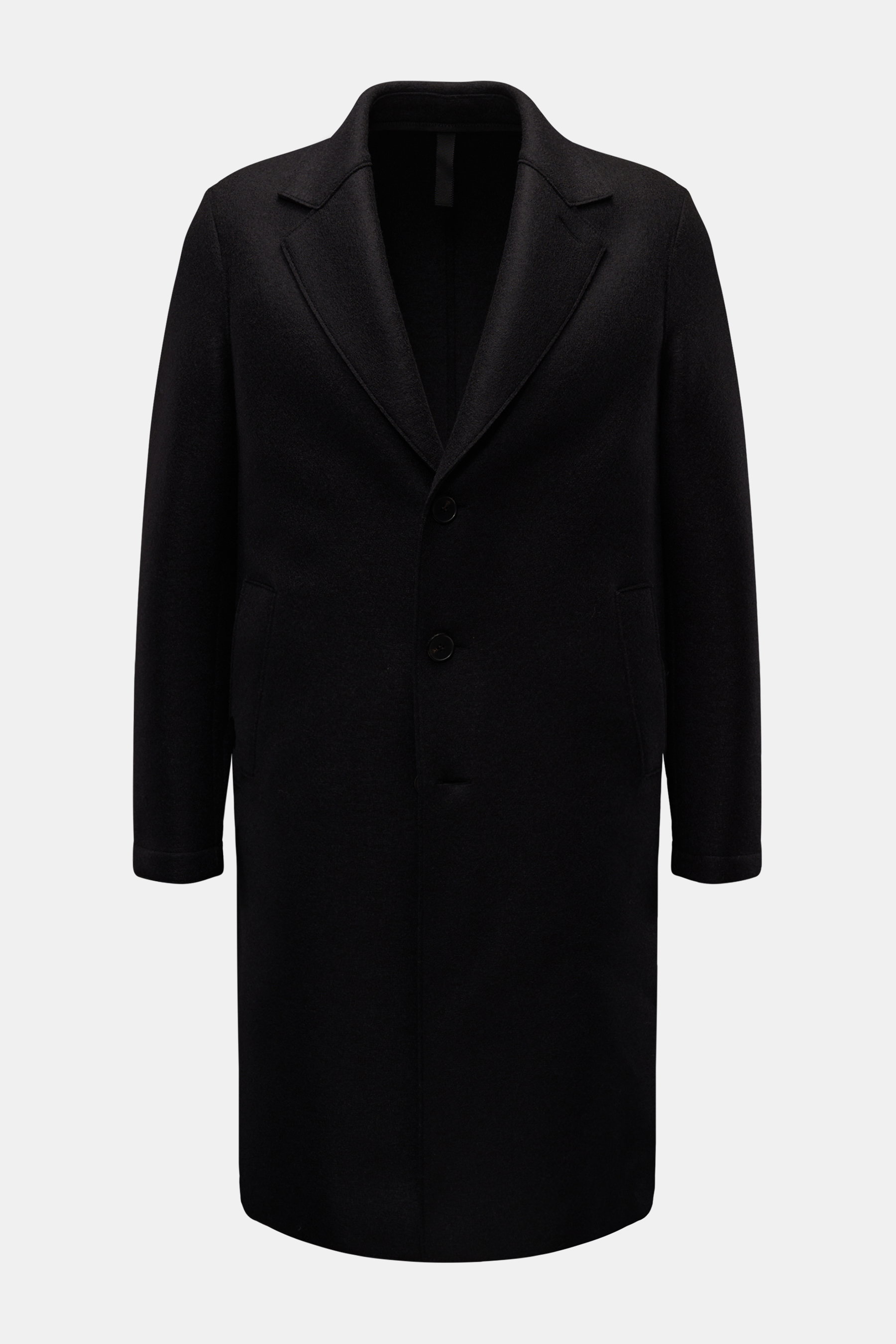 Harris Wharf London Wool coat black shown from the front, timeless unlined virgin wool coat with notch collar, three-button placket, slanted welt pockets, knee-length cut, and center back vent. Timeless, pure, and well thought out: This unlined coat with 
