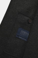 Close-up front angled view of Harris Wharf London Wool coat dark grey melange showing textured virgin wool, button, welt pocket, and label.

<p>Timeless, pure, and well thought out: This unlined coat with a straight silhouette from HARRIS WHARF LONDON, ma