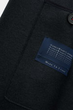 Close-up of the Harris Wharf London Wool coat navy showing navy felted virgin wool texture, button, and inside label, front inside view.