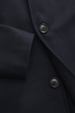 Close-up front view of the Doppiaa Coat 'Aaladin' navy showing five-button front, turn-down collar, made of soft wool blend with slant welt pockets. Italian coolness to throw on: The 'Aaladin' coat by DOPPIAA made of wool blend can be perfectly combined w