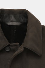 Close-up front view of the Brioni Dark Brown Sherling Coat showcasing its noble suede leather, soft sherling lining, turn-down collar, and four-button placket.

<p>This winter, you can shine with this noble suede leather coat by BRIONI, which also keeps y