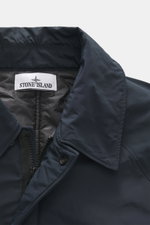 Close-up front view of the Stone Island Short Coat 'Micro Reps' navy showing the turn-down collar, high-quality microfiber with smooth touch, two-way zipper, wind flap with buttons, and quilted lining fabric. Features wind and water repellent fabric, warm